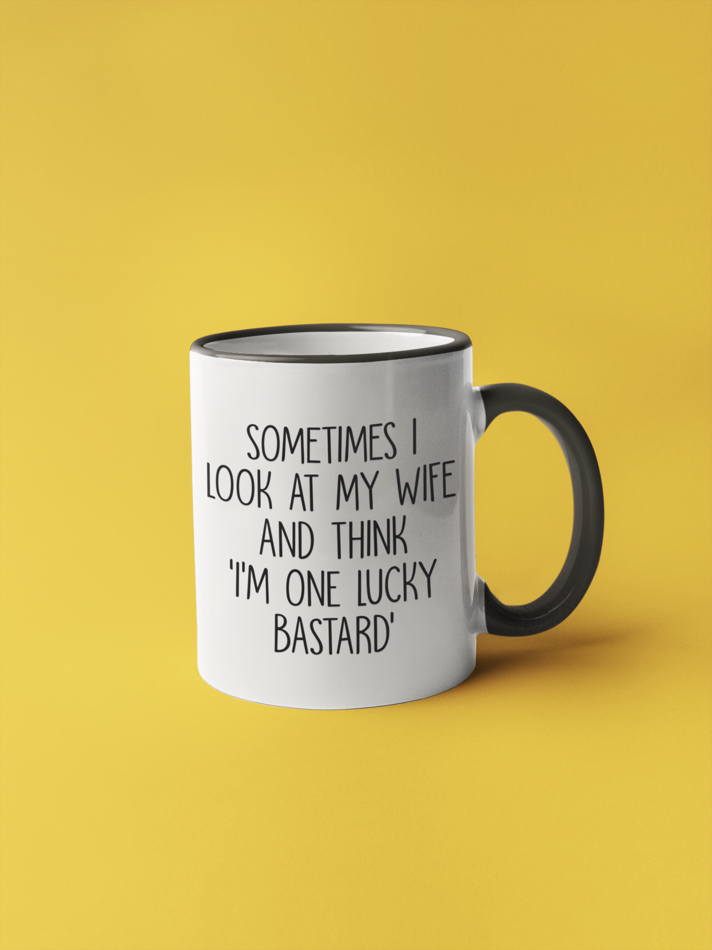 White mug with a black handle. It features the funny quote 'sometimes i look at my wife and think i'm one lucky bastard''. Printed in black ink.