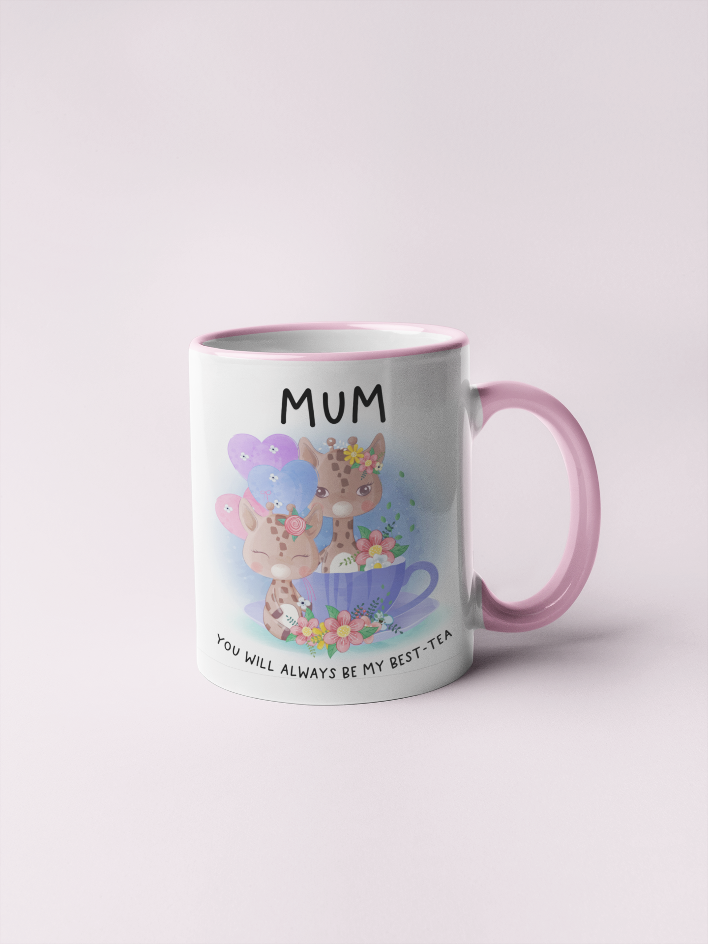 white mug with a pink handle featuring cute pastel colour giraffes sitting in a teacup with the word 'mum' at the top and to the bottom is reads 'you will always be my best-tea'.