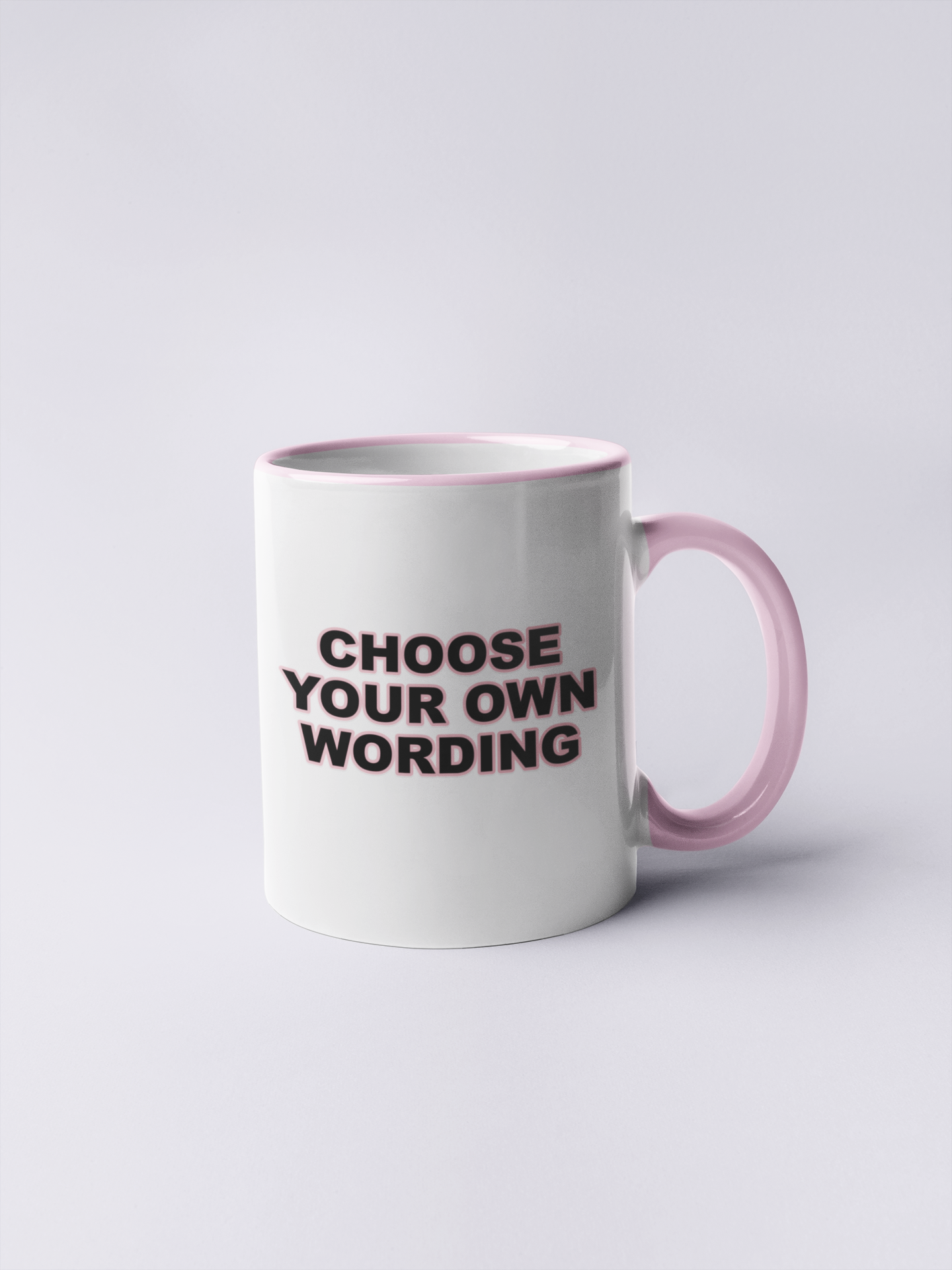 White mug with a pink handle and pink inner with the words choose your own wording, printed in black ink with a pink outline.