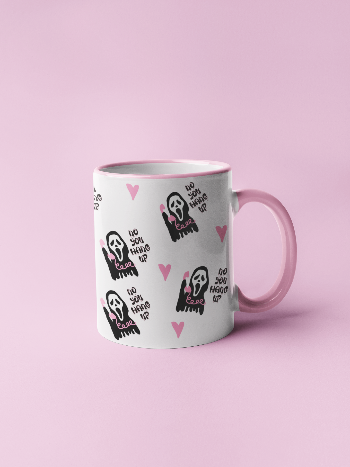 A mug featuring a design taken from the scream film, with the famous mask and quote 'no you hang up'. All in pretty pink and black colours.