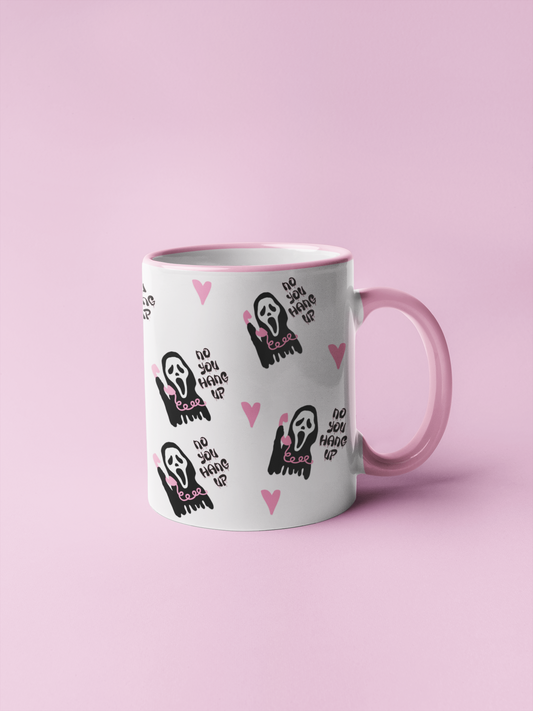 A mug featuring a design taken from the scream film, with the famous mask and quote 'no you hang up'. All in pretty pink and black colours.