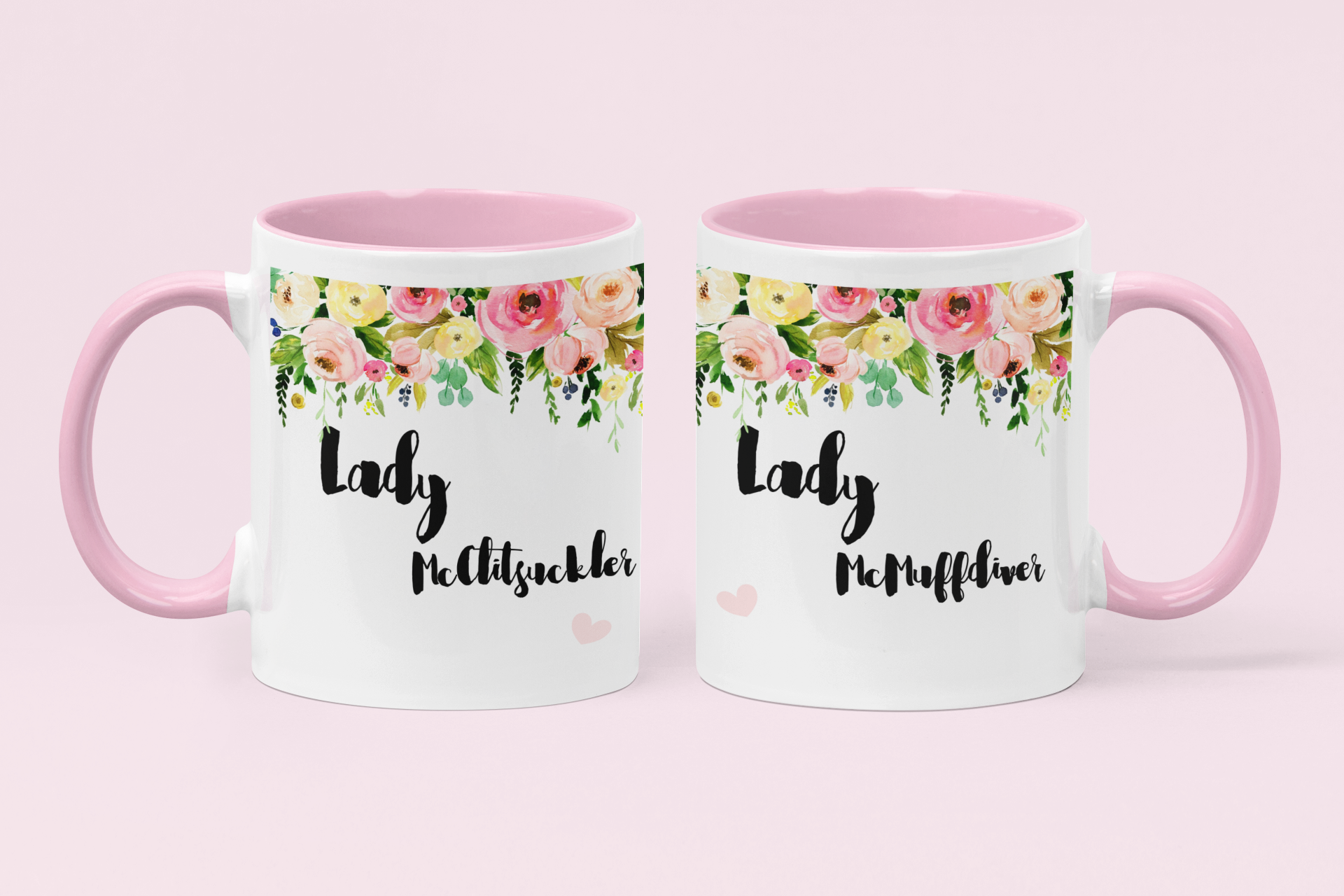 A pair of white mugs with pink handles & a colourful floral banner to the top. Under is the funny quotes ' lady mcclitsuckler' and 'lady mcmuffdiver'.