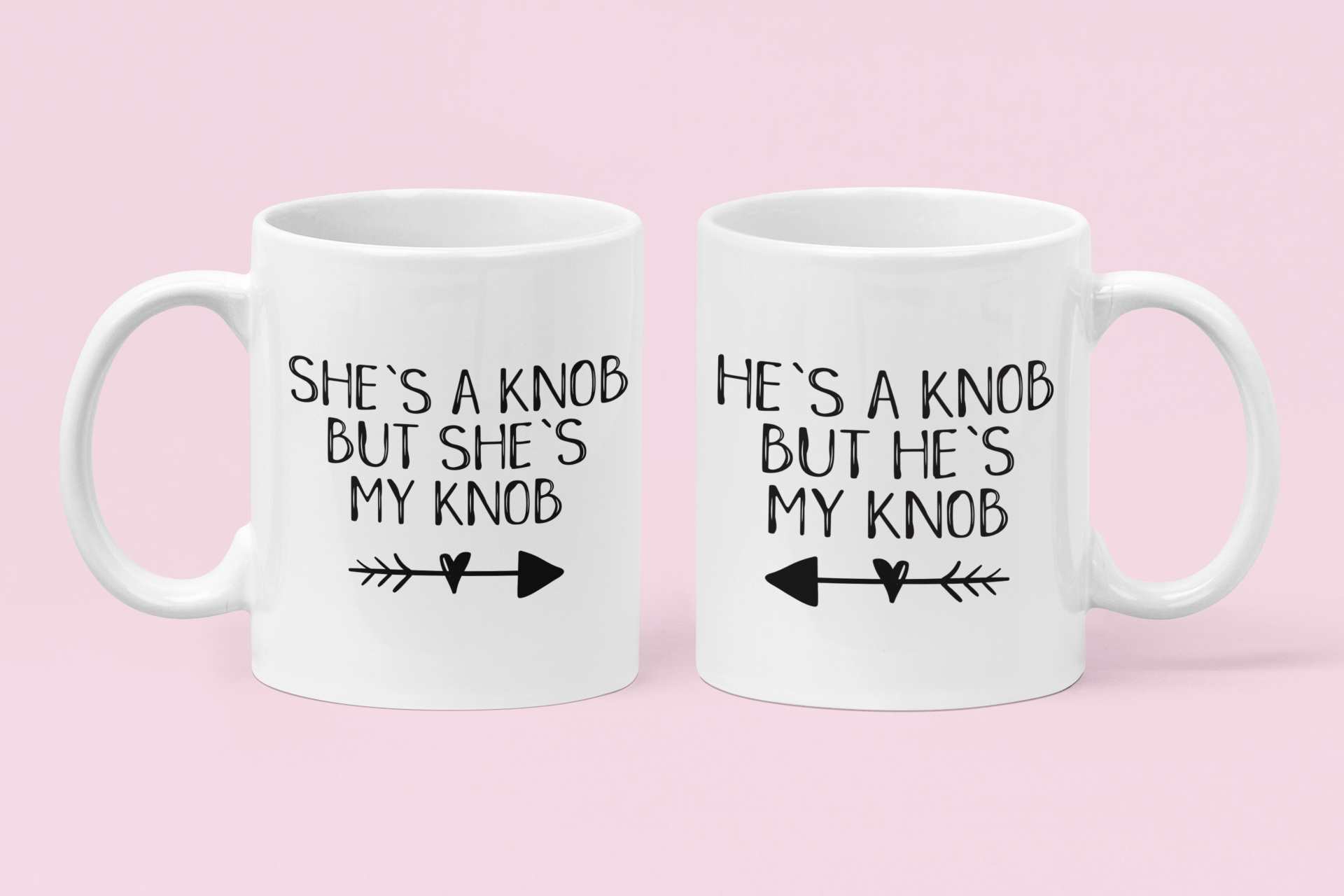 A pair of white ceramic mugs. One has 'he's a knob, but he's my knob' with an arrow underneath pointing to the left. The other has 'she's a knob, but she's my knob' with the arrow pointing to the right. Both printed to the front in black ink.