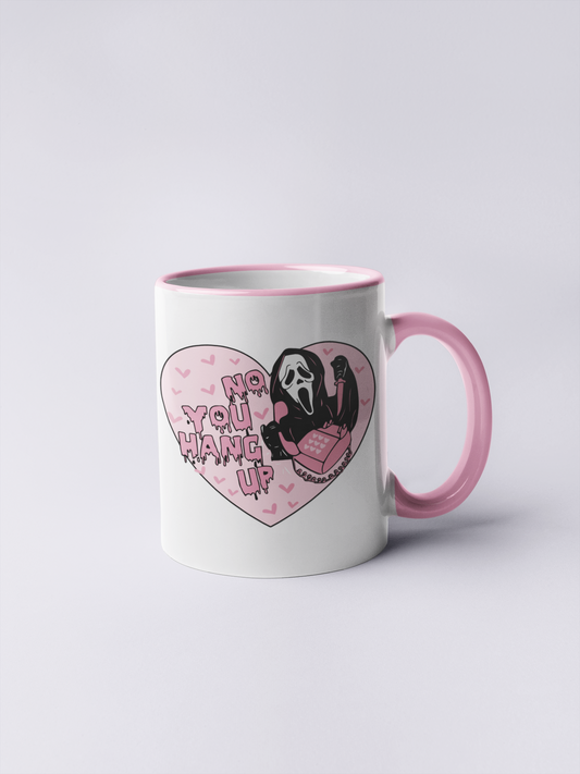 A mug featuring a design taken from the scream film, with the famous mask and quote 'no you hang up'. All in pretty pink and black colours.