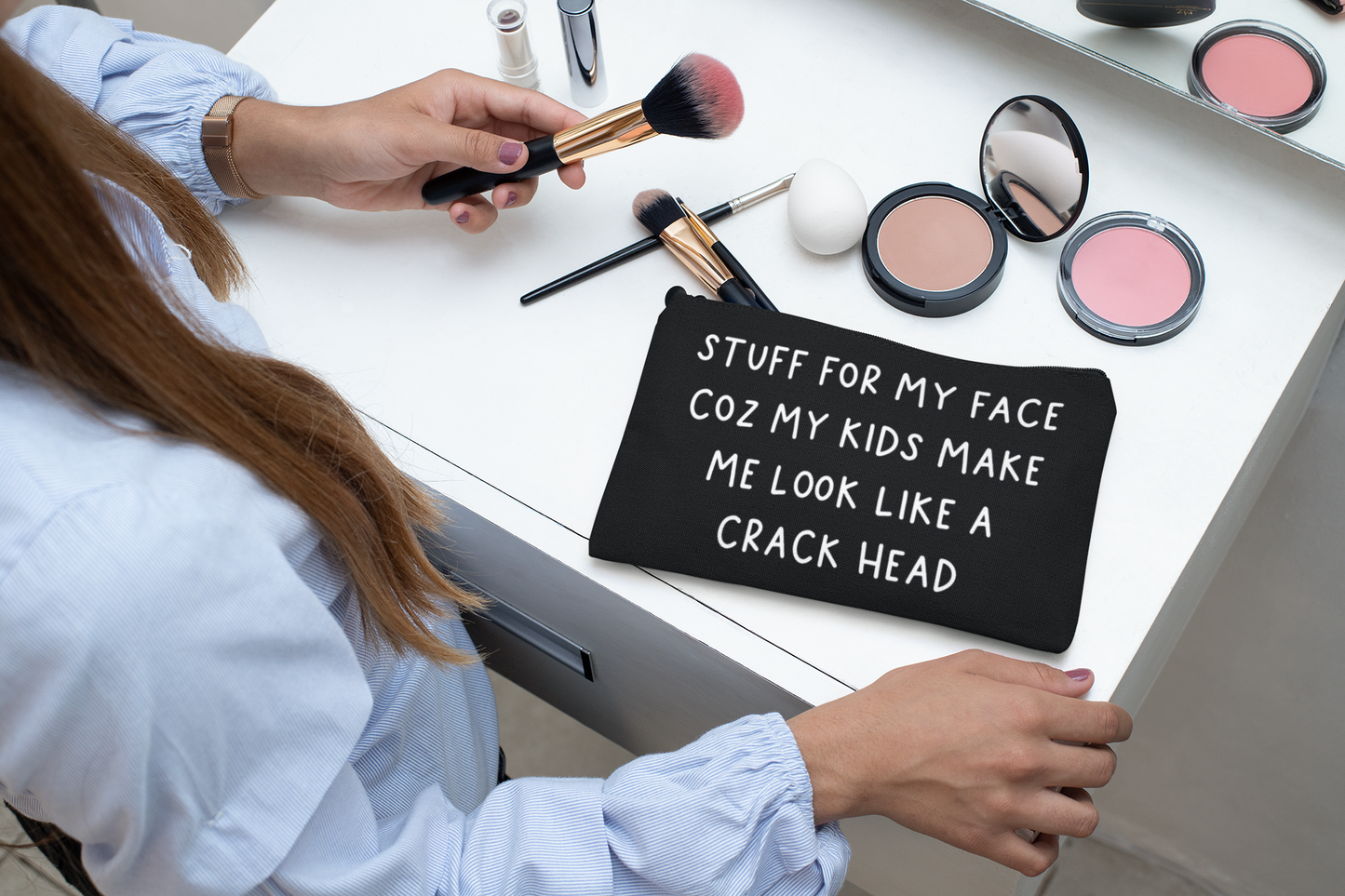 Black canvas make up bag with white lettering to the front featuring the funny quote 'stuff for my face coz my kids make me look like a crack head'. 