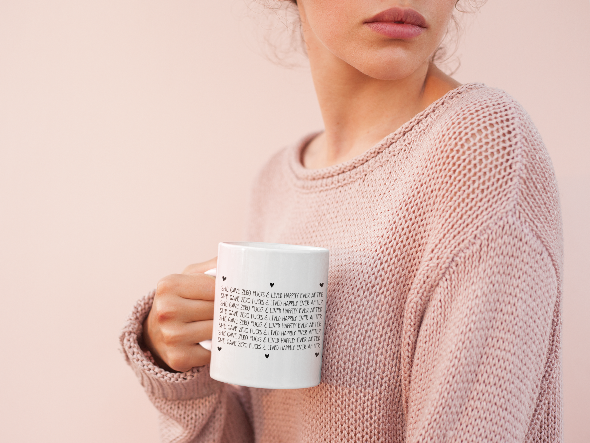 White mug with a repetitive design which says she gave zero fucks and lived happily ever after, with black  hearts surrounding the design.