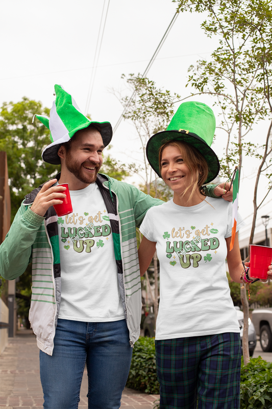 White tshirt with a St Patricks day logo to the front which reads 'let's get lucked up' with the word 'fucked' over the top of the word luck. In bold green colours with clovers surrounding the design.