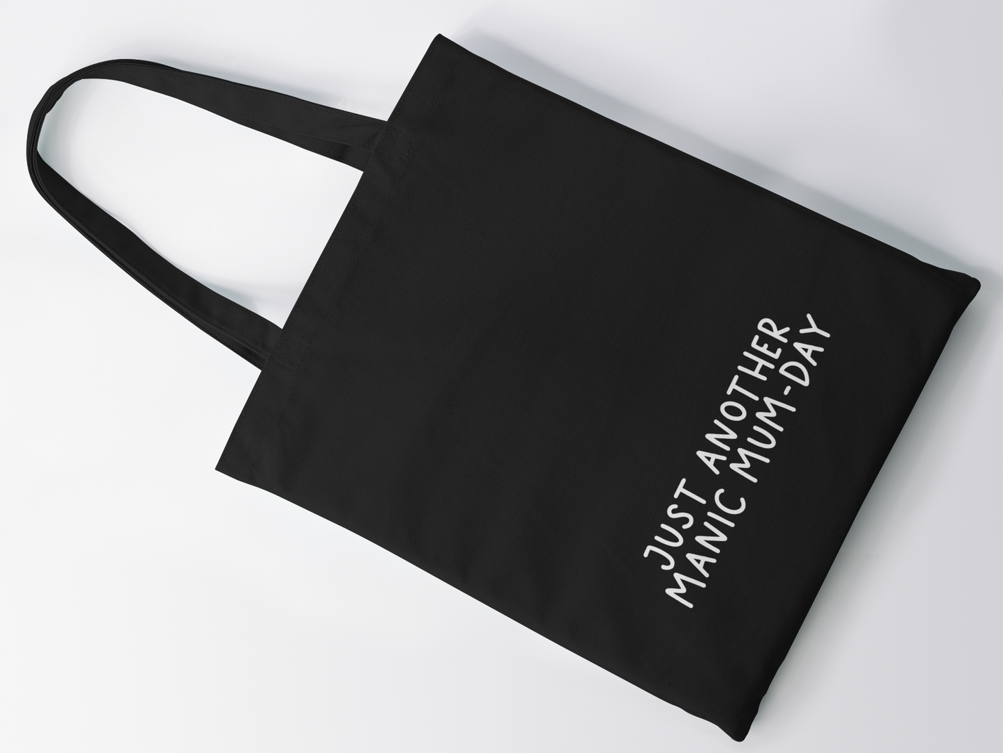 Black cotton tote bag with a quote to the bottom whoch reads 'just another manic mum-day' in white lettering.