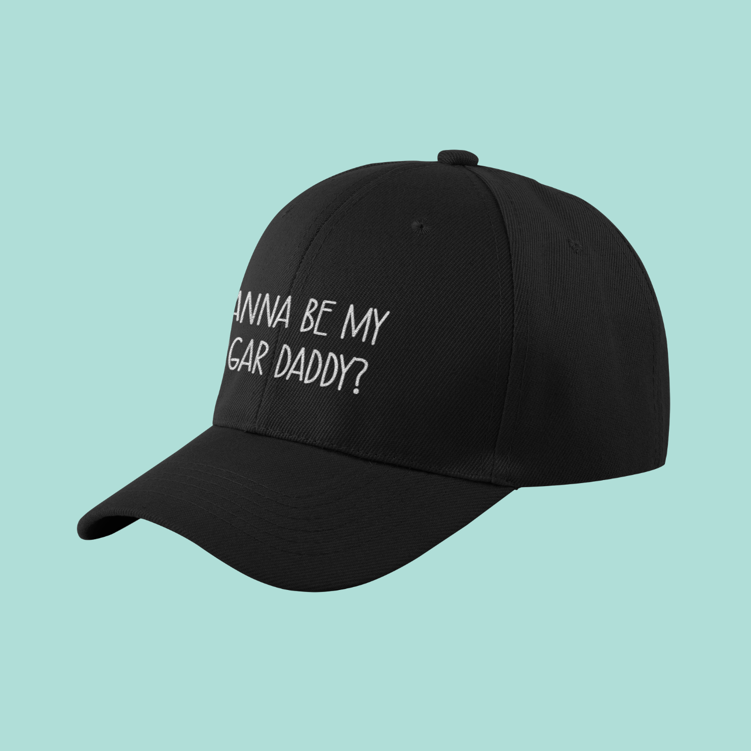 A black cotton cap with white lettering to the front which reads 'wanna be my sugar daddy?'.