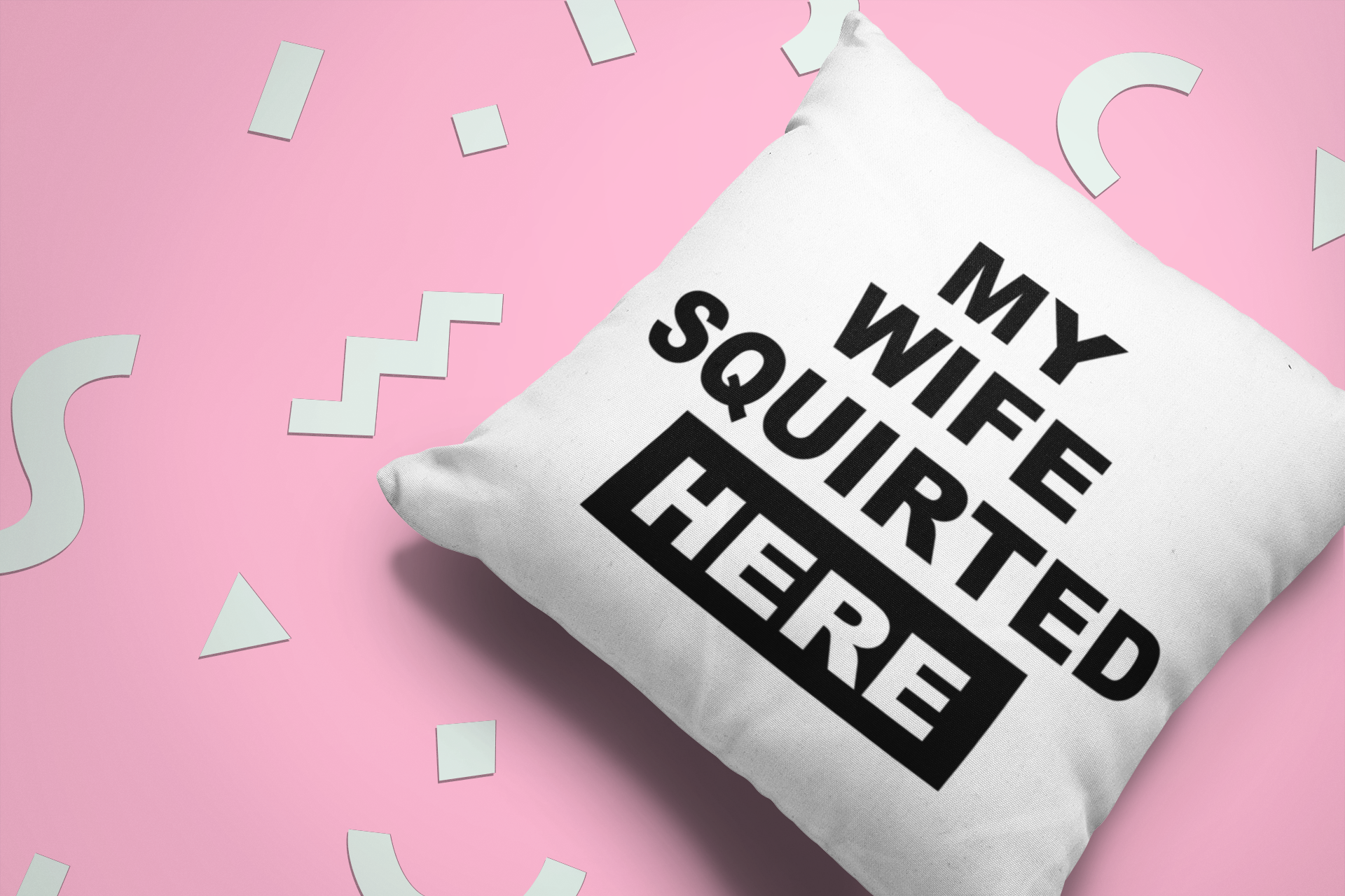White, square cushion with bold text to the front saying 'my wife squirted here'.